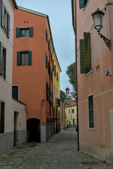 A charming cobblestone lane winds its way through the historic heart of Padua, Italy. Soft hues and old lanterns charm with quiet elegance. Each cobblestone holds echoes of centuries past.