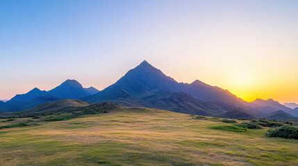 Majestic mountain silhouettes against soft pastel sky at sunset create serene landscape