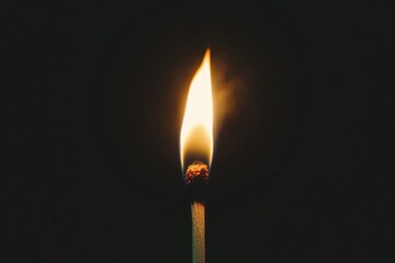 Burning match lights up darkness with intense flame in on black background, Burning match on a black background in