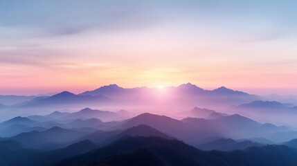 Layered mountain silhouettes fade into sunrise haze, creating serene landscape