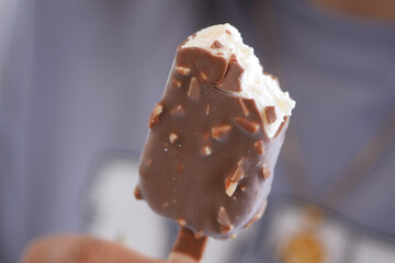 Delicious chocolate-covered ice cream bar with bites taken out