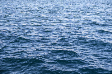 blue water surface background. small waves in the sea.