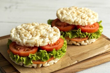 A photograph of rice cake sandwiches with tomato and lettuce