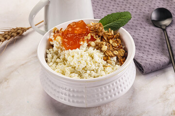 Curd with granola and orange jam