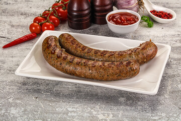 Grilled beef sausages with sauce