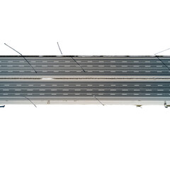 Aerial view of a highway with lane markings and street lights up