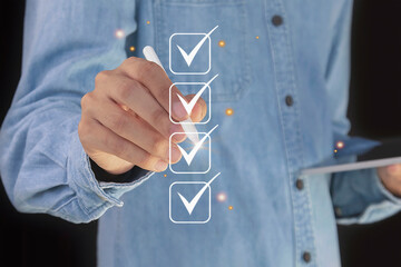 Checklist concept. Businessman is marking checkboxes.	