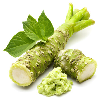 Fresh wasabi root with grated paste and green leaves on white background