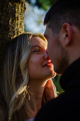 Fototapeta premium Young man and woman. Beautiful couple walking in the park. Romantic walk, photo shoot. Blonde and brunette