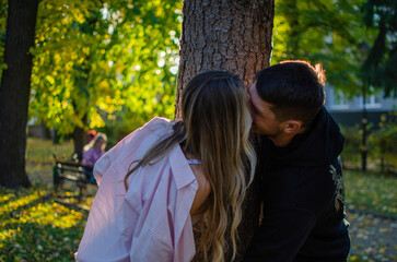 Fototapeta premium Young man and woman. Beautiful couple walking in the park. Romantic walk, photo shoot. Blonde and brunette
