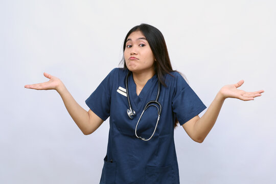 Young beautiful doctor woman wearing medical uniform over isolated background clueless and confused expression with arms and hands raised. Doubt concept.