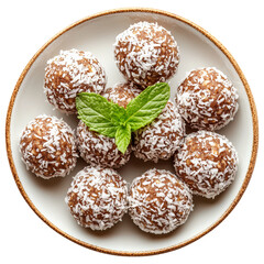 A plate of cute, round, brown and white colored energy balls with coconut shavings on top, mint leaves as garnish