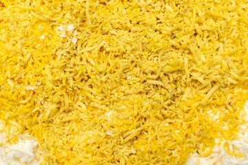 Close up view of a detail of salad with scrambled eggs and cheese 