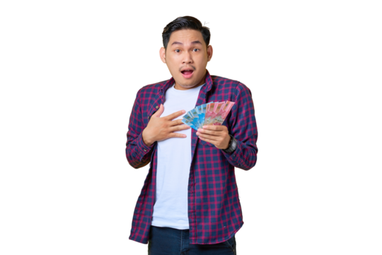 Surprised young Asian man in plaid shirt holding money banknotes with open mouth isolated on transparent background