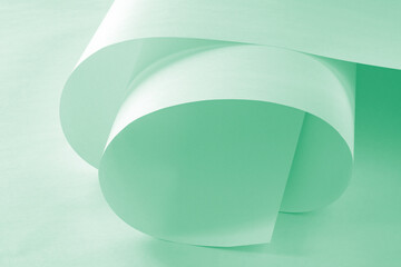 Unrolled roll of paper in green pastel tone.