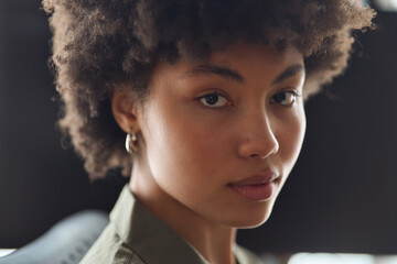 Young adult pretty beautiful confident gen z African American woman student with curly afro hair,...