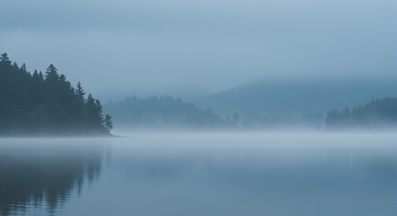 Fototapeta premium Serene Misty Lake Landscape with Reflections in Early Morning Light