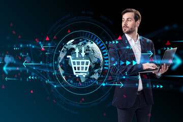 Businessman using laptop with ecommerce hologram and digital sales icon overlay on abstract dark background representing online economy concept.