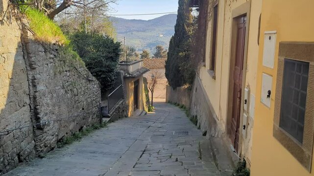 Explore the lovely hillside street, showcasing unique architecture and serene landscapes. Ideal for travel videos or relaxation purposes, inviting nature lovers and adventurers.