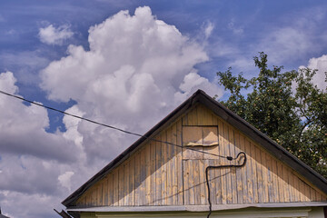 the roof of an old country house against the sky