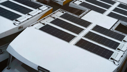 solar-powered boat docked on shore, traveling electric propulsion system under bright sunlight, reflects sustainable technology, peaceful maritime lifestyles future of green transportation. © chaiwat