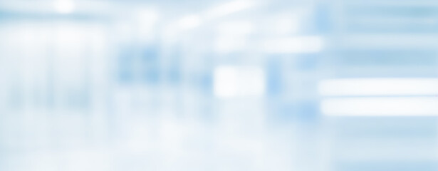 Blurred abstract background with soft blue and white tones creating a neutral backdrop.