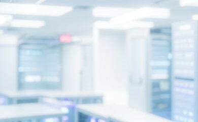 Blurred server room interior with racks and equipment white and blue tones.