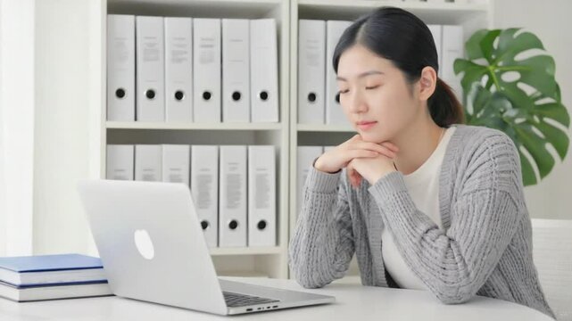 Young businesswoman looking at a laptop