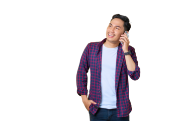 Smiling young Asian man in plaid shirt talking on mobile phone and looking away at copy space isolated on transparent background