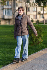 Teenage girl walking along a path in a spring city park