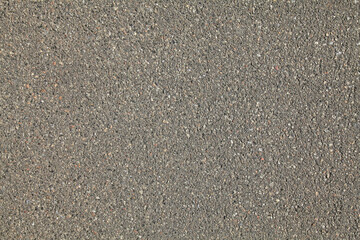 An old, faded asphalt surface, background. Detailed texture of the bitumen with abstract pattern....