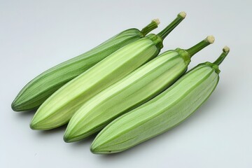 Fototapeta premium Four fresh zucchinis displayed on a clean surface, showcasing their vibrant colors and texture