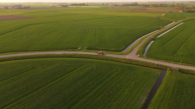 Aerial Side-Follow of Tractor Driving Through Frisian Landscape &ndash; Netherlands