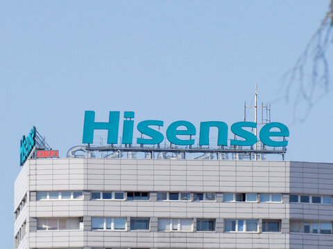 Hisense Bright Turquoise Corporate Sign on White Office Building Under Blue Sky