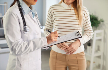Consulting, making notes, results checking in feminist health clinic, supporting caring female doctor meeting, greeting, consulting young woman patient, offering medical advice in gynecology