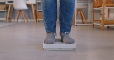 Close up of feet on floor scales with person measuring weight and monitoring progress. Concept of dieting, healthy lifestyle and weight loss journey, focusing on fitness goals and slimming efforts.