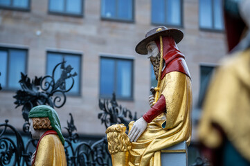 Nuremberg, Germany, August 2, 2023. Detail of one of the many statues that characterize the golden fountain in the market square. Travel destinations and tourist attractions.