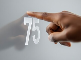 Number Seventy Five with a Hand Touching It