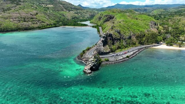 Aerial view of the emerald Indian Ocean meeting cliffs and coastal curves at the famous Maconde Viewpoint, Mauritius
