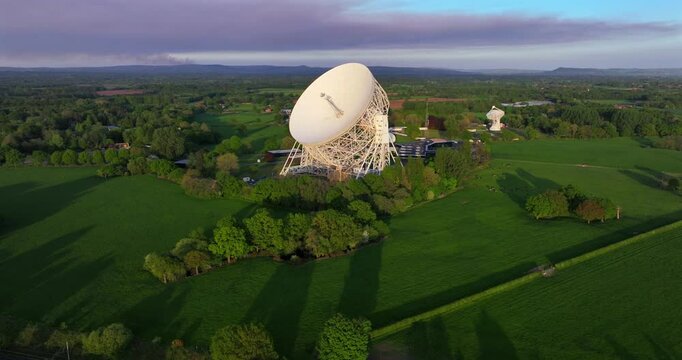 Aerial video of a countryside landscape with a large radio telescope dish in Jordell Bank - UK 