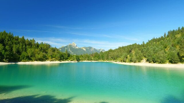 Idyllic Urisee Lake with crystal-clear water and mountain views in Tyrol, peaceful setting for relaxation and summer recreation