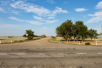 Scenic rural crossroads in Kazakhstan under clear blue sky in summer season