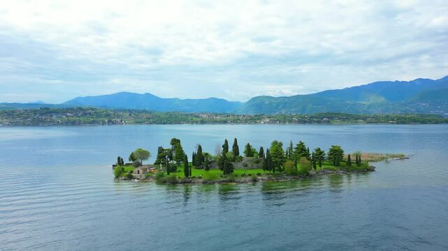 Drone shot of the islet of Conigli on Lake Garda in the province of Brescia in Lombardy, Italy