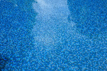 Swimming pool water surface and ripple wave with blue mosaic tiles