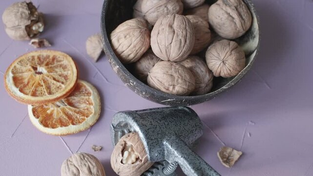 shelled walnuts and metal nutcracker in close-up	