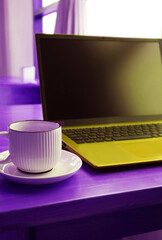 Pop Art Style of Ultramarine Mustard Yellow Opened Laptop with a Coffee Cup on Purple Table