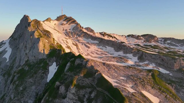 9 juli 2024, Wildhaus, Switzerland. Forward turn Drone flight, during sunrise in Alpstein mountains. S&auml;ntis mountain during sunrise. Impressive mountain with some snow. Wonderful Alps.
