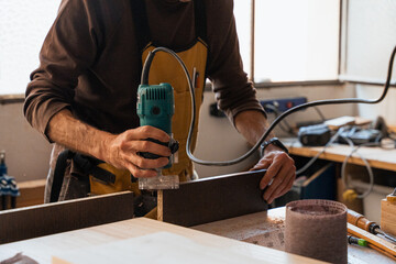 Carpintero en taller de carpintería con herramientas