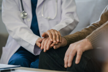 Obraz premium Hands of medical personnel comforting to reassure the elderly man patient in clinic.