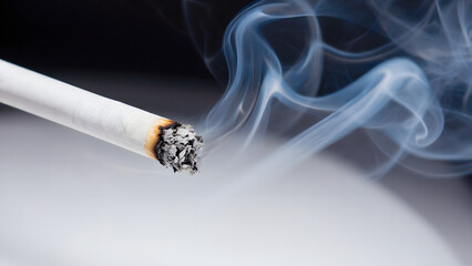 Isolated on a black backdrop, a white smoking cigarette releases toxic tobacco smoke, a visual representation of addiction, unhealthy habit, and the danger of cancer